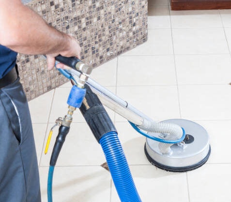 Person operating a professional floor cleaning machine